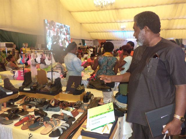 A buyer inspecting leather works by Yasco Footwear Technology at the trade exhibition